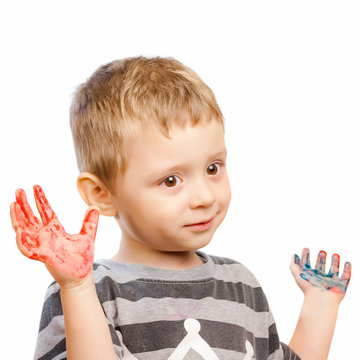 Little boy with hands painted in colorful paints ready for hand prints over white background