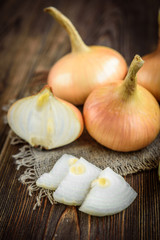 Onion on dark wooden background.