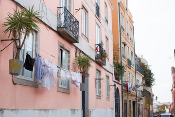 Fototapeta na wymiar Old Houses in a an Old European City with Laundry and Flowers on Balcony