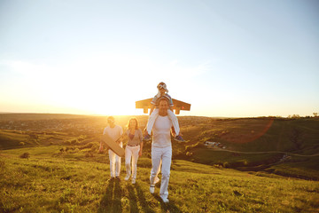 Happy family with nature in the evening at sunset.