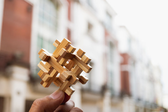 Hand holding wooden interlocking using as business and education concept