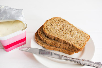 Soft cheese open package knife white background.