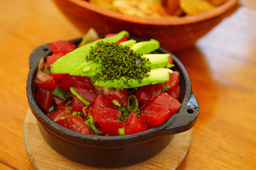 Eating a bowl of Hawaiian ahi tuna poke with avocado