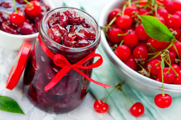 Delicious cherry jam in sugar syrup in jar