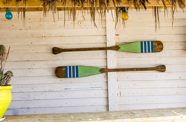Canoe paddles hanging on the wall.