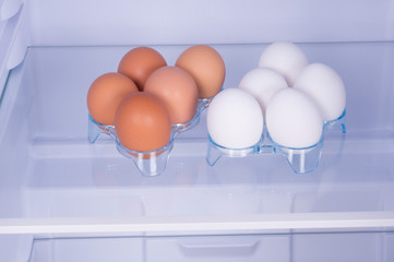 Eggs on a white shelf of the refrigerator, healthy nutrition concept