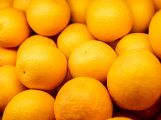 Closeup of many Oranges on a market. Background
