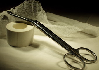 scissors, bandage and adhesive plaster