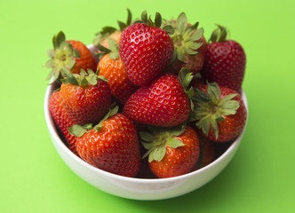 Bowl of Beautiful Red Strawberries on a Bright Green Table