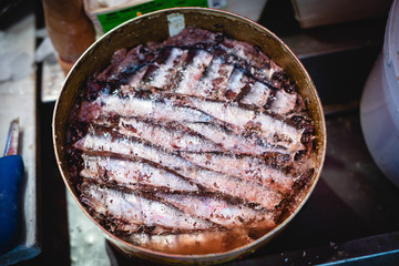 salted anchovies exposed in a tin can at the catania fish market. Characteristic Sicilian dish of the fishing towns.