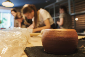 Making dirty hands of raw clay ware in a pottery workshop