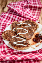 Homemade oat pancakes with strawberry jam and sour cream on wooden background. Healthy breakfast.