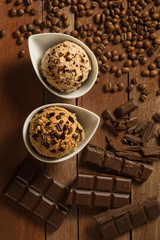Homemade scoops of ice cream chocolate and coffee on wooden background