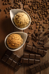 Homemade scoops of ice cream chocolate and coffee on wooden background