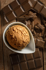 Homemade scoops of ice cream chocolate on wooden background