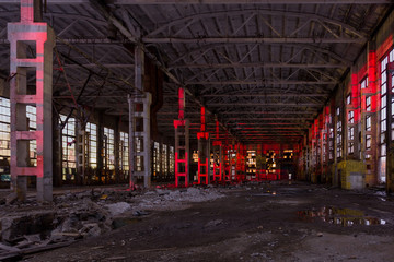 Large industrial hall illuminated by red lights. Abandoned Voronezh excavator plant