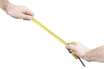 Male hand holding a metal tape measure, making measurements, isolated on white background, first-person view