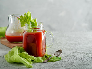 Tomato juice in mason jar with celery and salt.