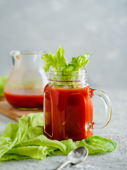 Tomato juice in mason jar with celery and salt.