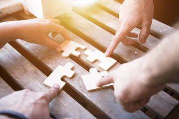 Business partnership or teamwork concept with a business people presenting a matching puzzle piece...