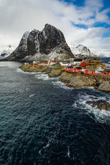 Fototapeta na wymiar Famous tourist attraction Hamnoy fishing village on Lofoten Islands, Norway with red rorbu houses in winter.