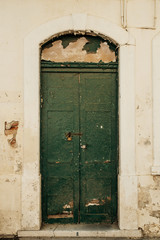 Old green wooden door in old abandoned bulding in Gibraltar.