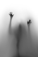 Help ! Spooky spirit, hands and fingers, and blurry body silhouette behind a textile curtain.