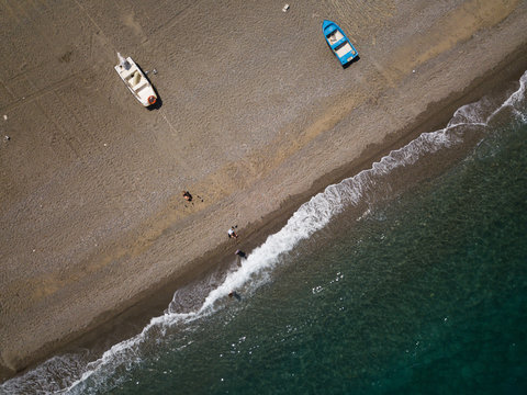 Sea shore, little fishing boats are parking at the beach, drone brids eye view, Sicily, Italy