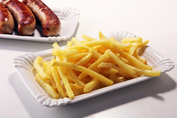 Grilled sausage served with french fries or fried potatoes with sausage