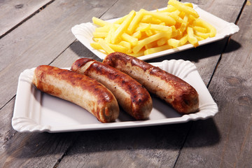 Grilled sausage served with french fries or fried potatoes with sausage