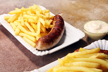 Grilled sausage served with french fries or fried potatoes with sausage