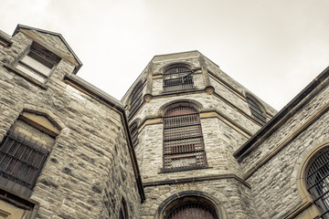 Looking up at a brick prison building