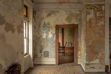 Fototapeta na wymiar Looking through a doorway of an old abandoned home