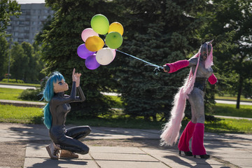 funny freaks, dressed in a unicorn bright costume and anime face mask with latex catsuit, enjoy...