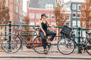 portrait of a beautiful fashionable young girl in the streets of Amsterdam, the Netherlands in the...
