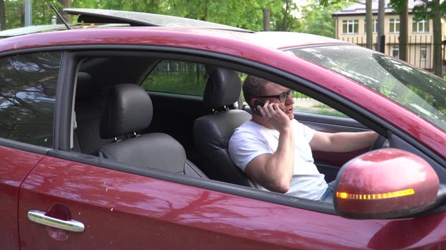 Man uses the phone after the car has broken down