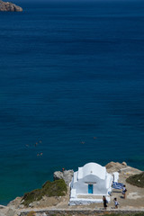 Amorgos, Greece-August 3, 2017.Small kids photographed in front of the small entrance of Agia Anna...