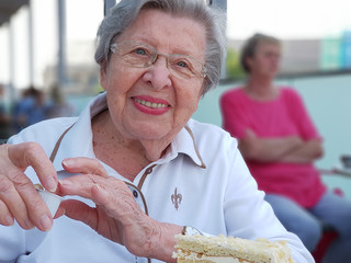 Senior Woman Sitting in Public