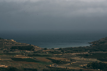 Fototapeta na wymiar Beautiful view from hill of Gozo to sea and fields