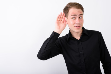 Young handsome businessman against white background