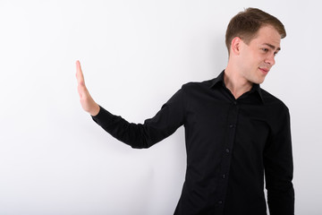 Young handsome businessman against white background