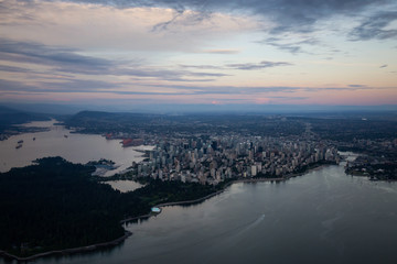 Aerial view of Downtown City during a vibrant cloudy sunset. Taken in Vancouver, British Columbia, Canada.