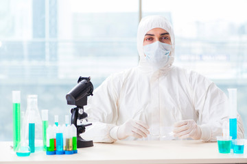 Young chemist student working in lab on chemicals