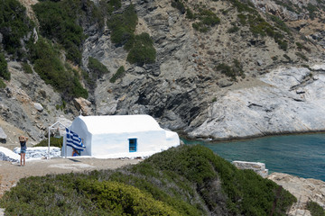 Amorgos, Greece-August 3, 2017.Small kids photographed in front of the small entrance of Agia Anna...