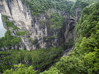 The Tianmen Mountain with a view of the cave Known as The Heaven's Gate surrounded by the green forest and mist at Zhangjiagie, Hunan Province, China, Asia