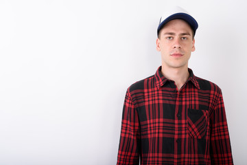 Young handsome man wearing baseball cap and red checkered shirt 