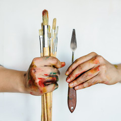 Close Up of an artist/painter hands holding paint brushes