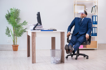 Employee using virtual reality glasses in office