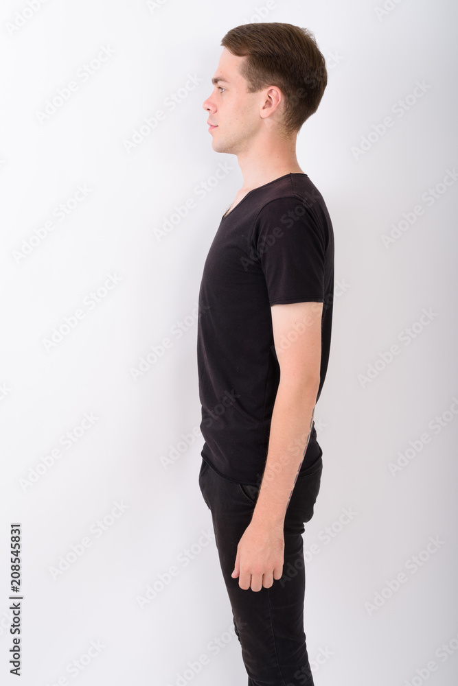 Wall mural Young handsome man against white background 