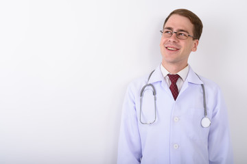 Fototapeta premium Young handsome man doctor wearing eyeglasses against white backg